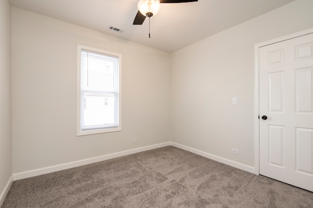 empty room featuring ceiling fan and carpet floors