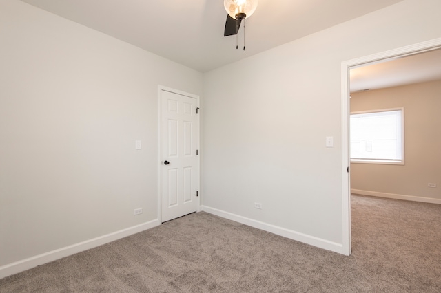 carpeted spare room with ceiling fan