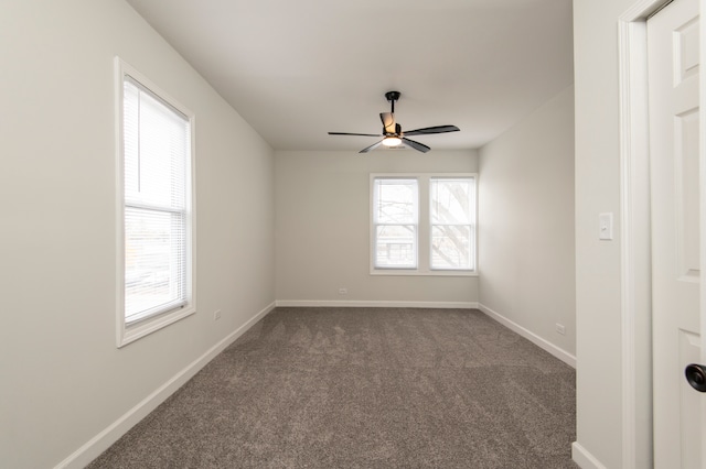 carpeted spare room with ceiling fan