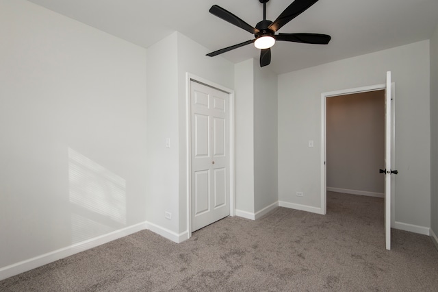 unfurnished bedroom with ceiling fan, light carpet, and a closet