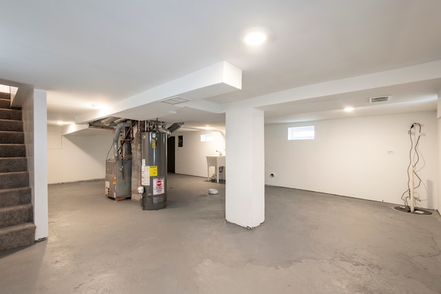 basement with gas water heater and sink