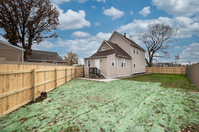 rear view of property with a yard