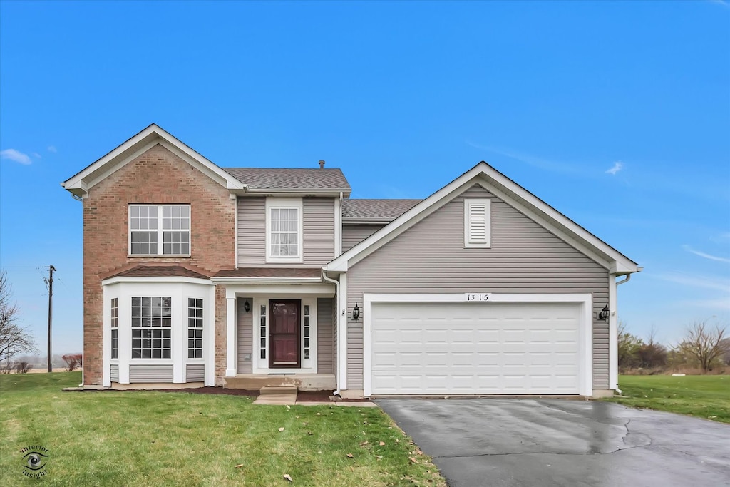 view of front of house featuring a front yard and a garage