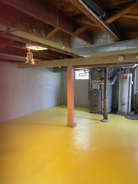 basement with gas water heater and heating unit