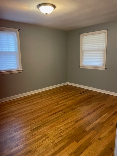 spare room with hardwood / wood-style floors