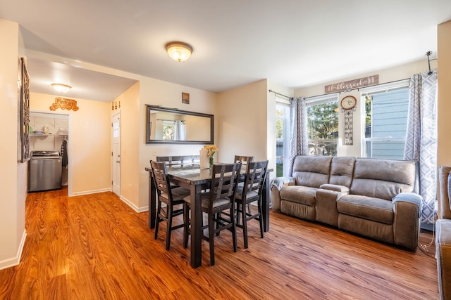 dining area featuring hardwood / wood-style floors and washer / dryer