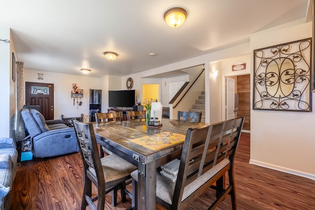 dining room with dark hardwood / wood-style floors