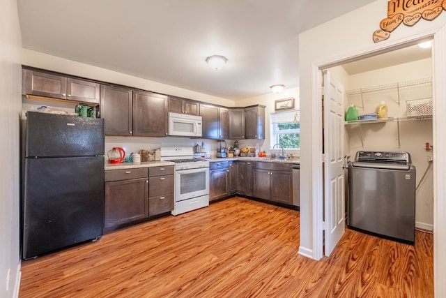 kitchen with washer / clothes dryer, dark brown cabinets, white appliances, and light wood-type flooring