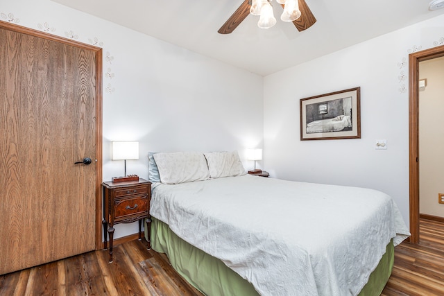 bedroom featuring ceiling fan and dark wood-type flooring