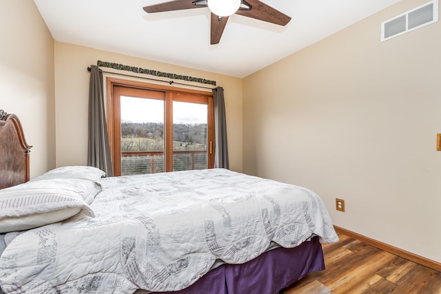 bedroom featuring hardwood / wood-style flooring, ceiling fan, and access to exterior