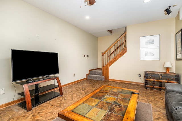 living room with dark parquet flooring and ceiling fan