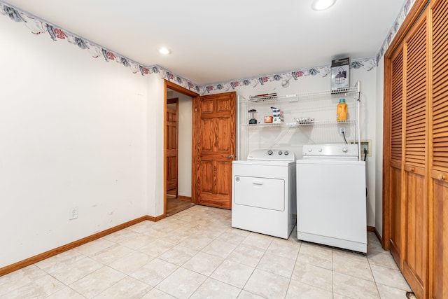 laundry area with light tile patterned flooring and washing machine and dryer