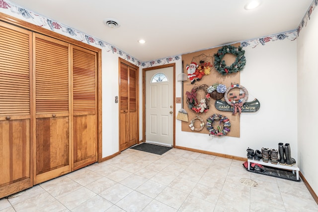 foyer entrance featuring light tile patterned floors