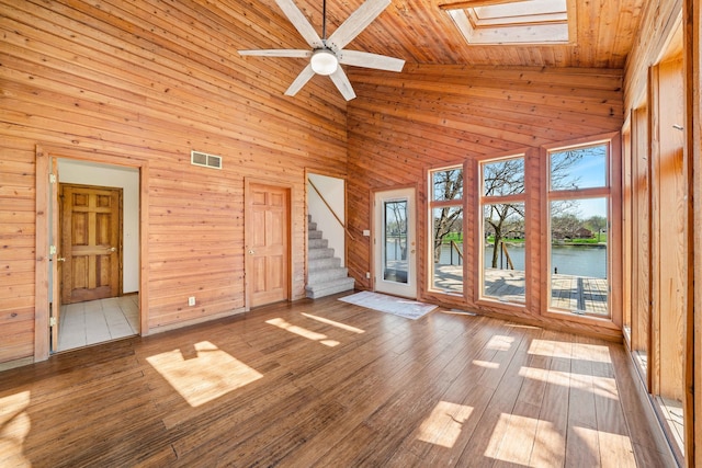 unfurnished room featuring high vaulted ceiling, a wealth of natural light, and wood ceiling