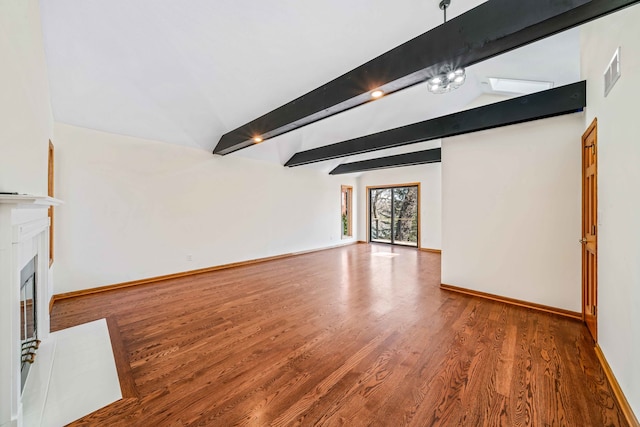 unfurnished living room featuring hardwood / wood-style floors and vaulted ceiling with beams