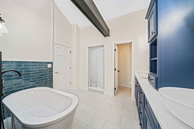 bathroom with tile patterned floors, plus walk in shower, vanity, and tile walls