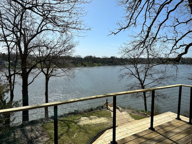 wooden terrace featuring a water view