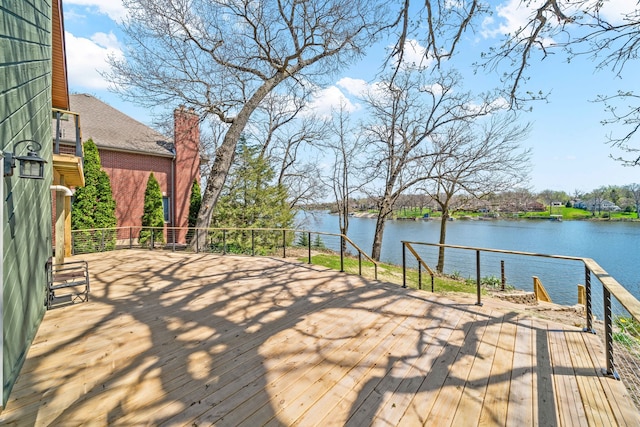 wooden terrace featuring a water view