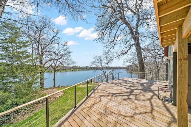 deck with a lawn and a water view