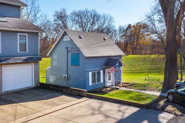 view of property exterior featuring a garage and a yard