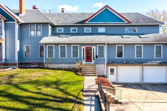 view of front of home with a garage and a front yard