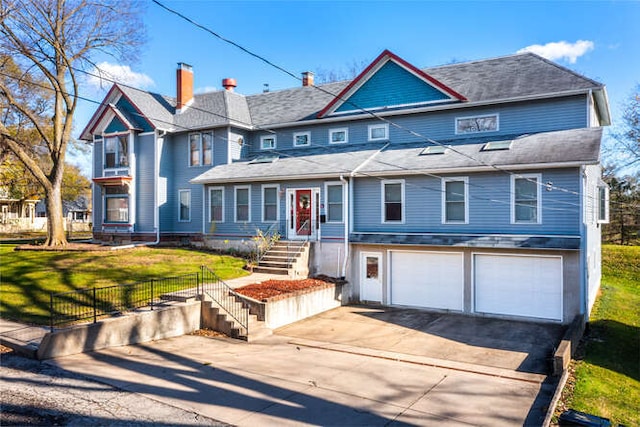 view of front facade featuring a front yard and a garage