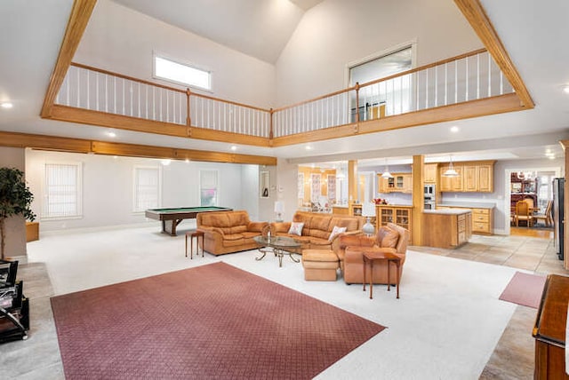 living room with pool table, light colored carpet, and a high ceiling