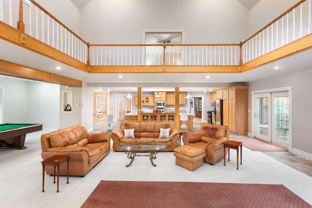 carpeted living room featuring ceiling fan, a towering ceiling, and pool table