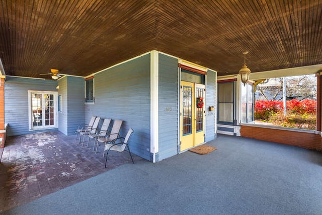 exterior space with lofted ceiling, ceiling fan, and wood ceiling