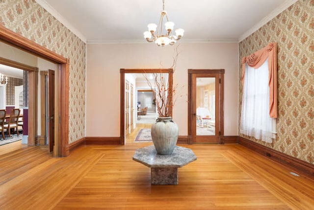 interior space featuring plenty of natural light, light hardwood / wood-style floors, and a notable chandelier