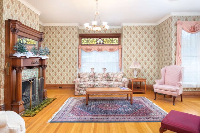 living room featuring hardwood / wood-style floors, ornamental molding, plenty of natural light, and an inviting chandelier