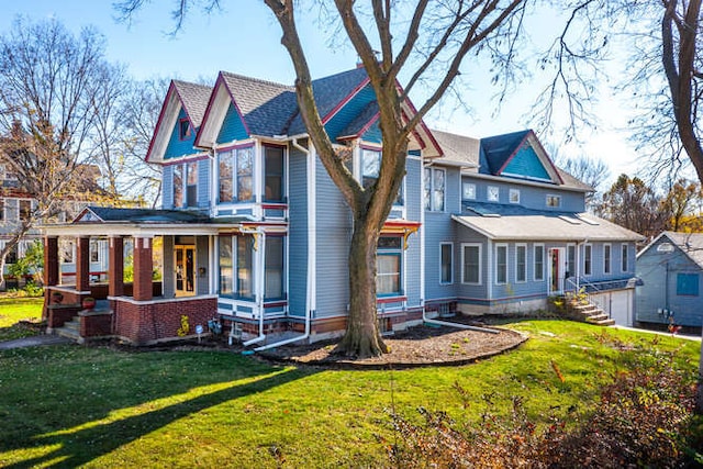 rear view of house featuring a lawn