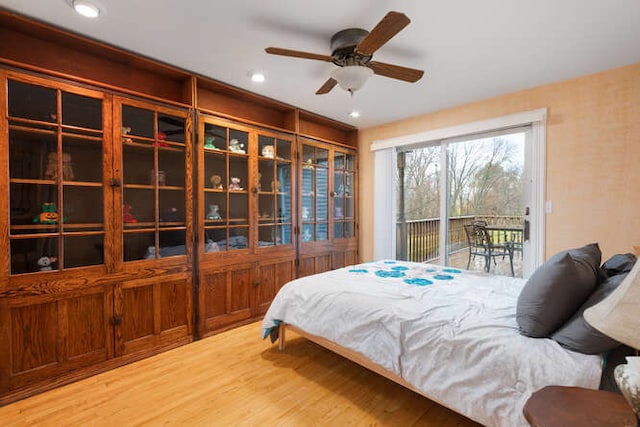 bedroom with hardwood / wood-style floors, ceiling fan, and access to outside