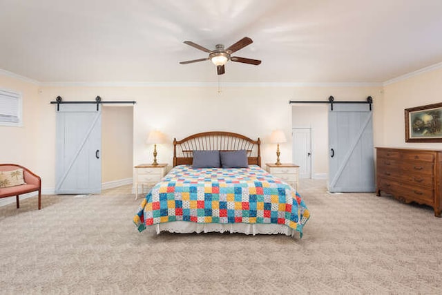 bedroom with ceiling fan, a barn door, light colored carpet, and crown molding