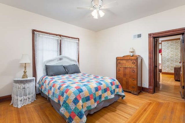 bedroom with wood-type flooring and ceiling fan