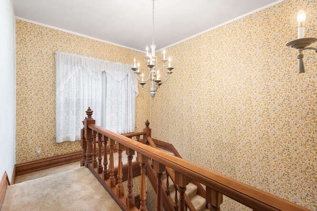 hallway featuring crown molding and a chandelier