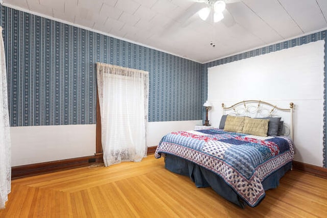 bedroom with hardwood / wood-style floors and ceiling fan