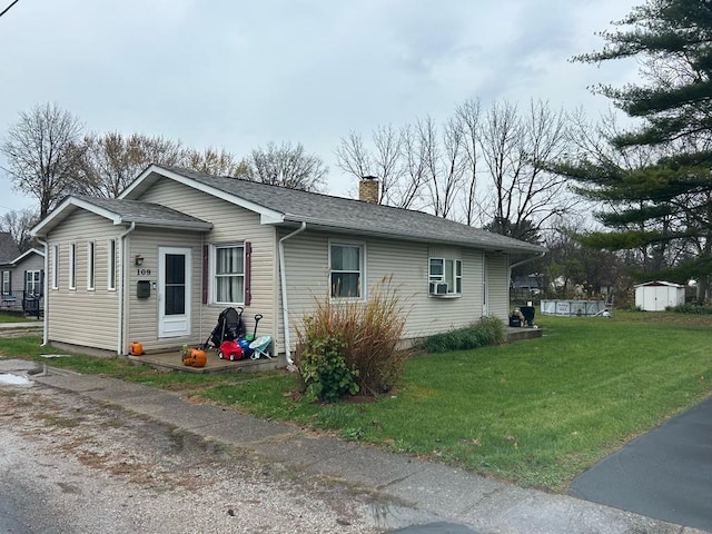 view of side of home featuring a lawn and cooling unit