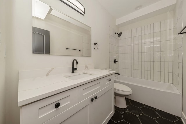 full bathroom with tile patterned flooring, vanity, tiled shower / bath combo, and toilet