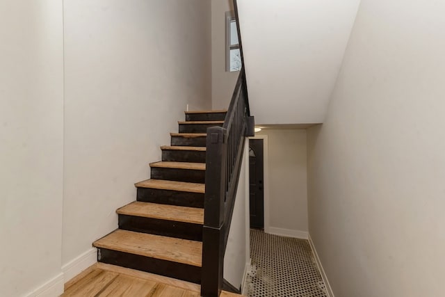 stairs featuring wood-type flooring