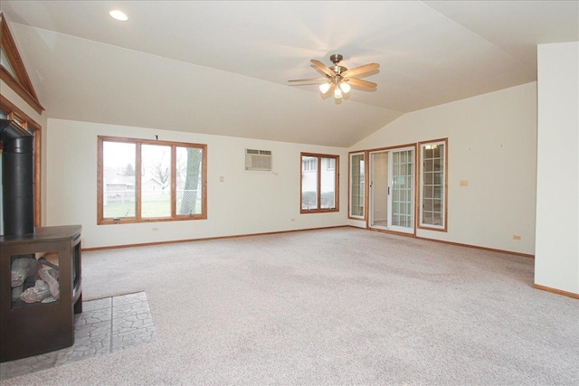 unfurnished living room featuring light carpet, a healthy amount of sunlight, and vaulted ceiling