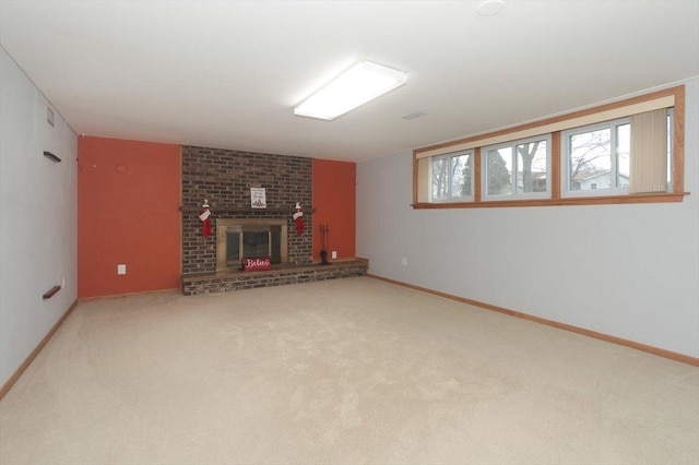 unfurnished living room with carpet flooring and a fireplace