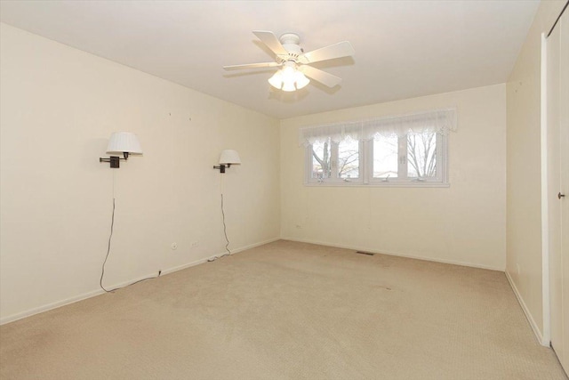 carpeted empty room featuring ceiling fan