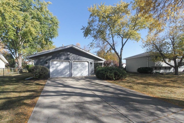 view of side of property with a lawn and a garage