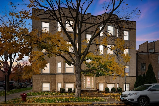 view of outdoor building at dusk