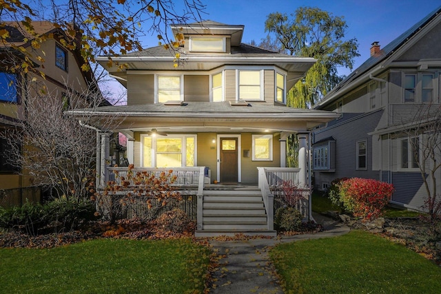 view of front of home featuring covered porch and a front yard