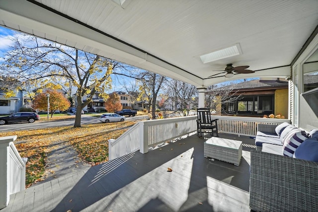 deck with a porch, an outdoor living space, and ceiling fan