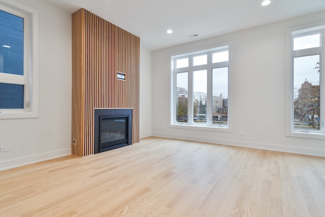 unfurnished living room with light wood-type flooring