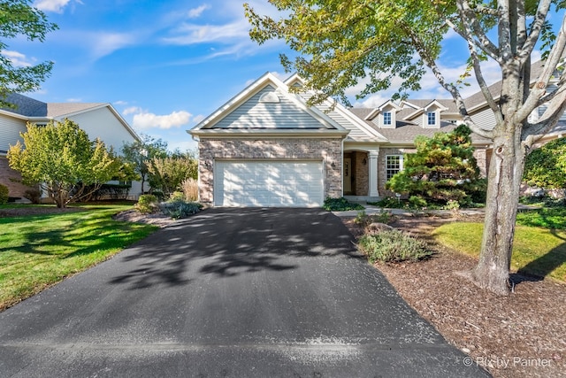 view of front of house with a garage and a front lawn