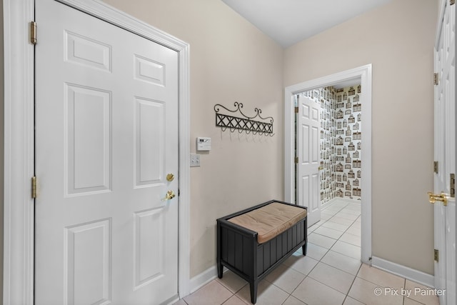 doorway with light tile patterned flooring